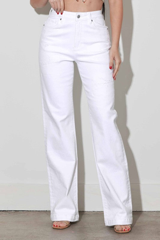 White jeans worn by a person on a plain background